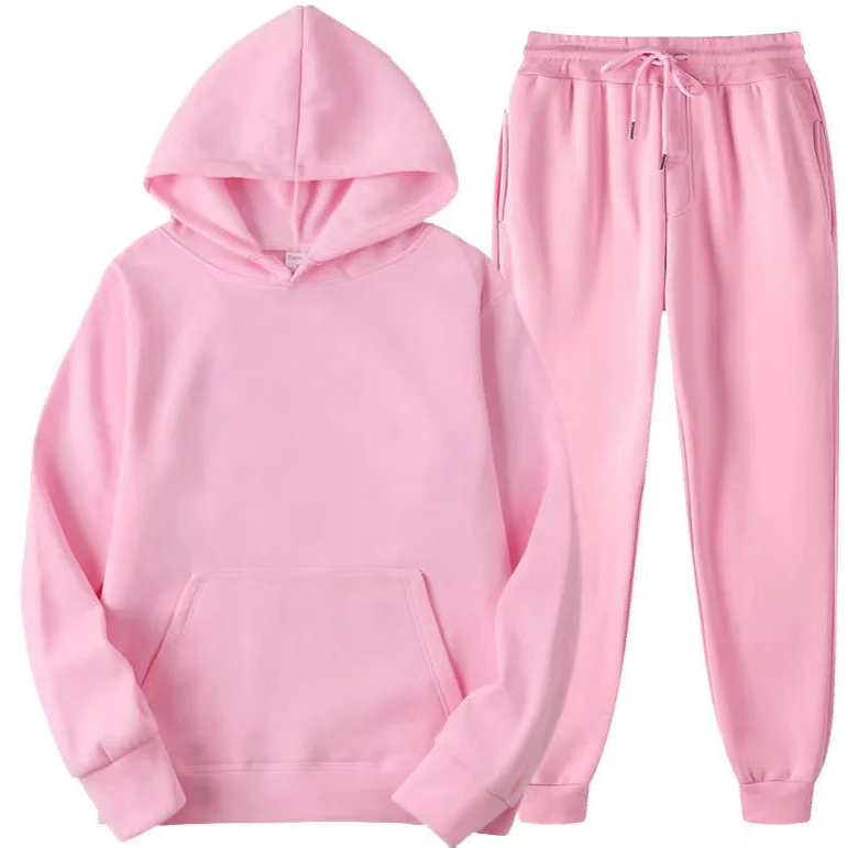 Pink hoodie and pants set on a white background